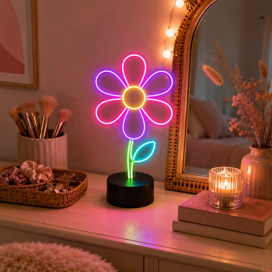 Daisy flower neon desk light glowing on a vanity beside a mirror and makeup brushes