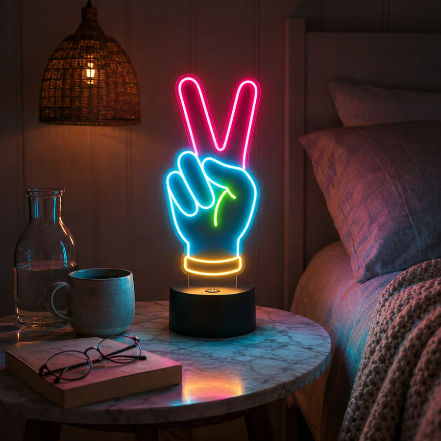 Peace hand neon desk light glowing on a marble nightstand beside a bed