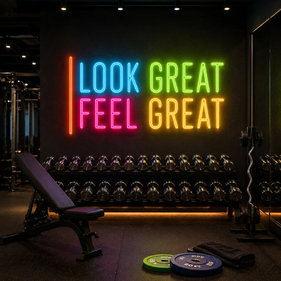 Look Great Feel Great neon sign glowing above a dumbbell rack in a modern gym