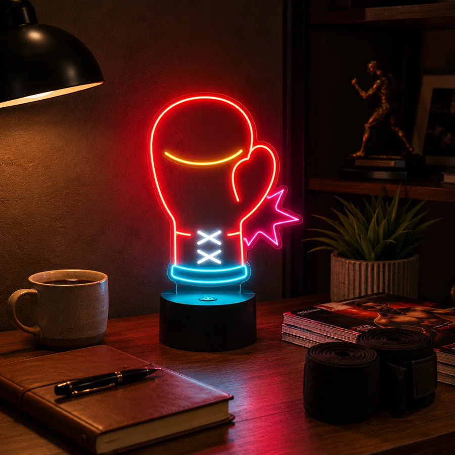 Boxing glove neon desk light glowing on a desk beside hand wraps and a notebook