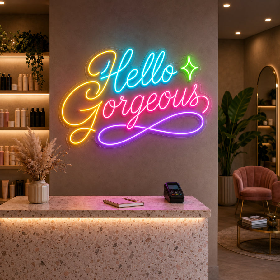Hello Gorgeous neon sign glowing at a salon reception