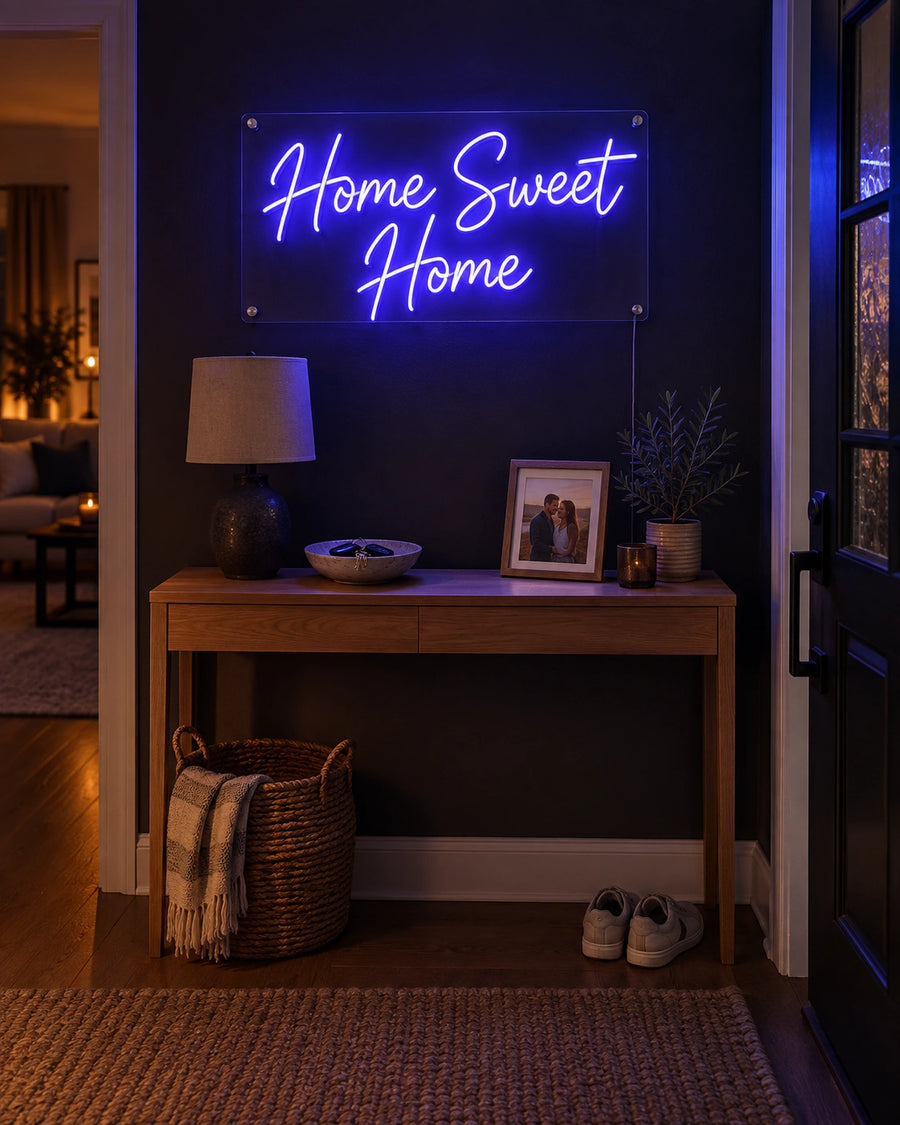 Home Sweet Home blue LED neon sign on an entryway wall beside a console table