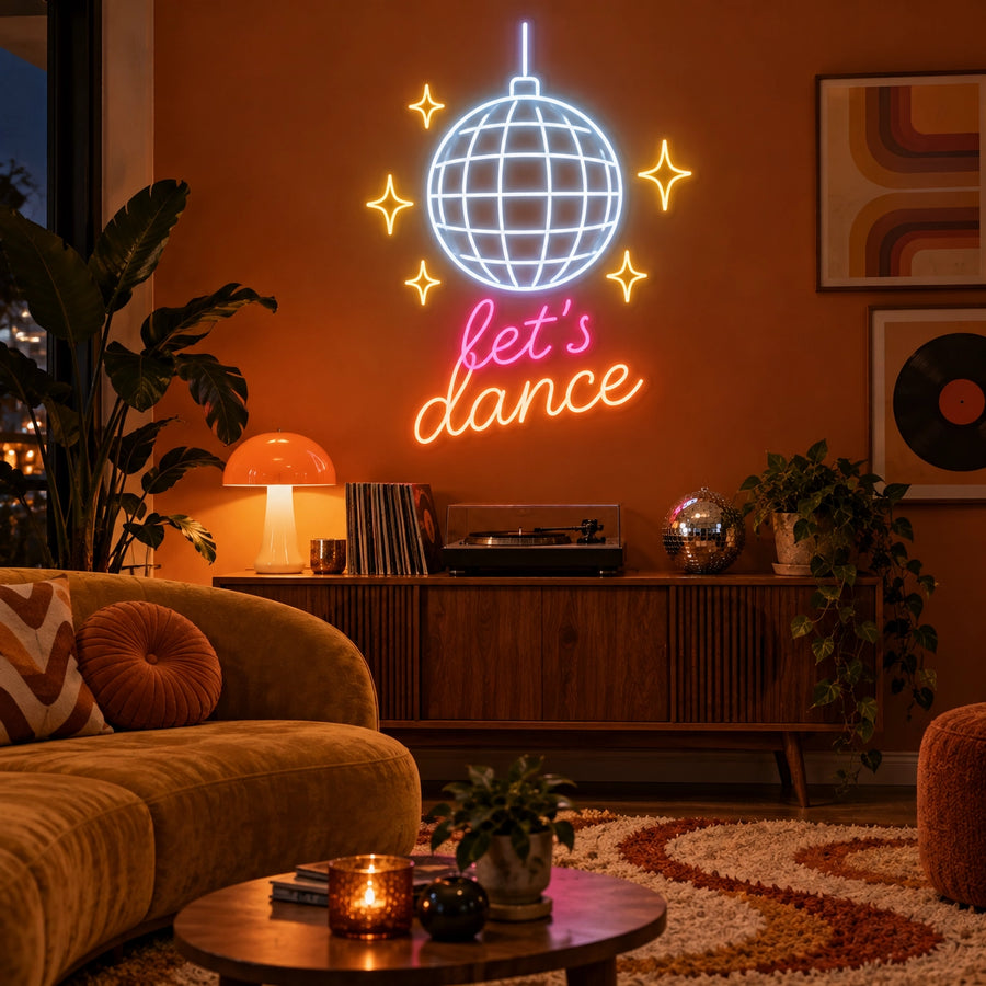 Let's Dance Disco Ball LED neon sign in white, gold, pink and orange in a living room