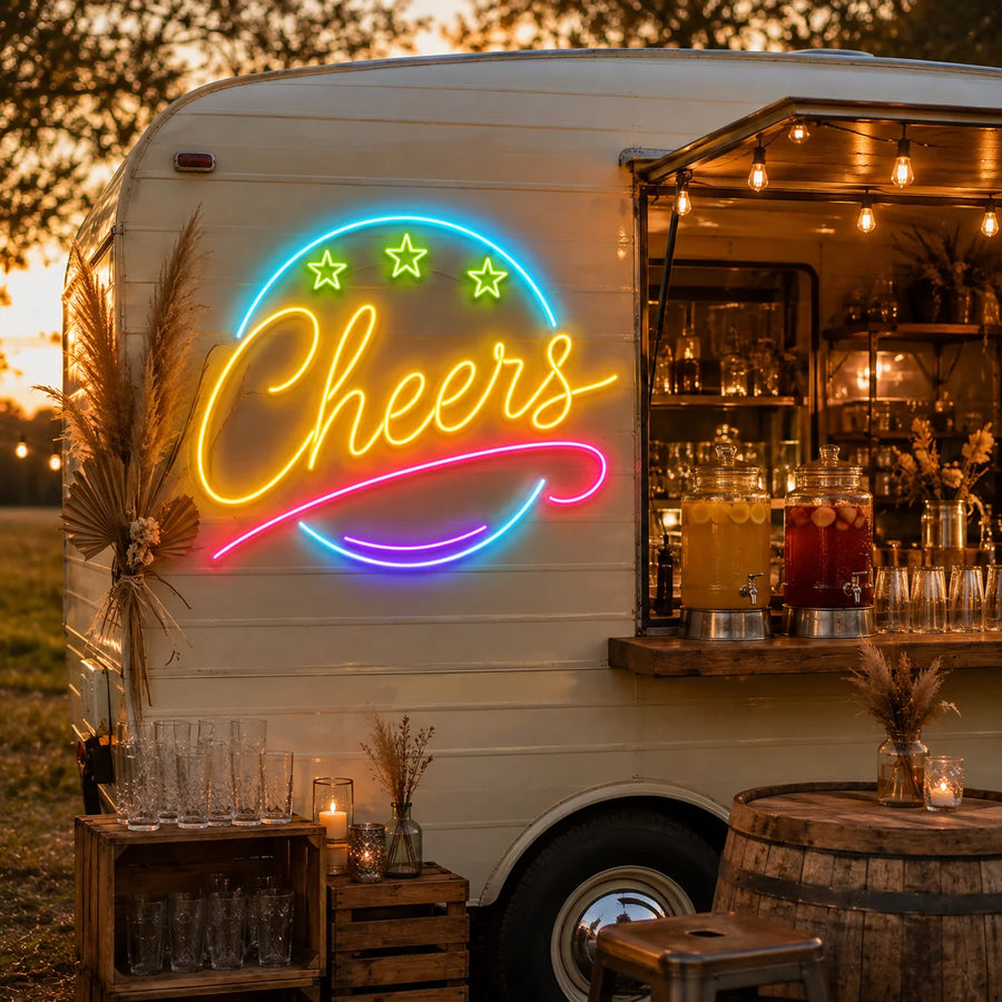 Cheers round badge neon sign on the side of a vintage bar trailer at sunset