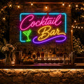 Cocktail Bar neon sign on a stone wall above an outdoor garden bar