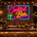 Cocktail Bar neon sign on a stone wall above an outdoor garden bar (alternate view)