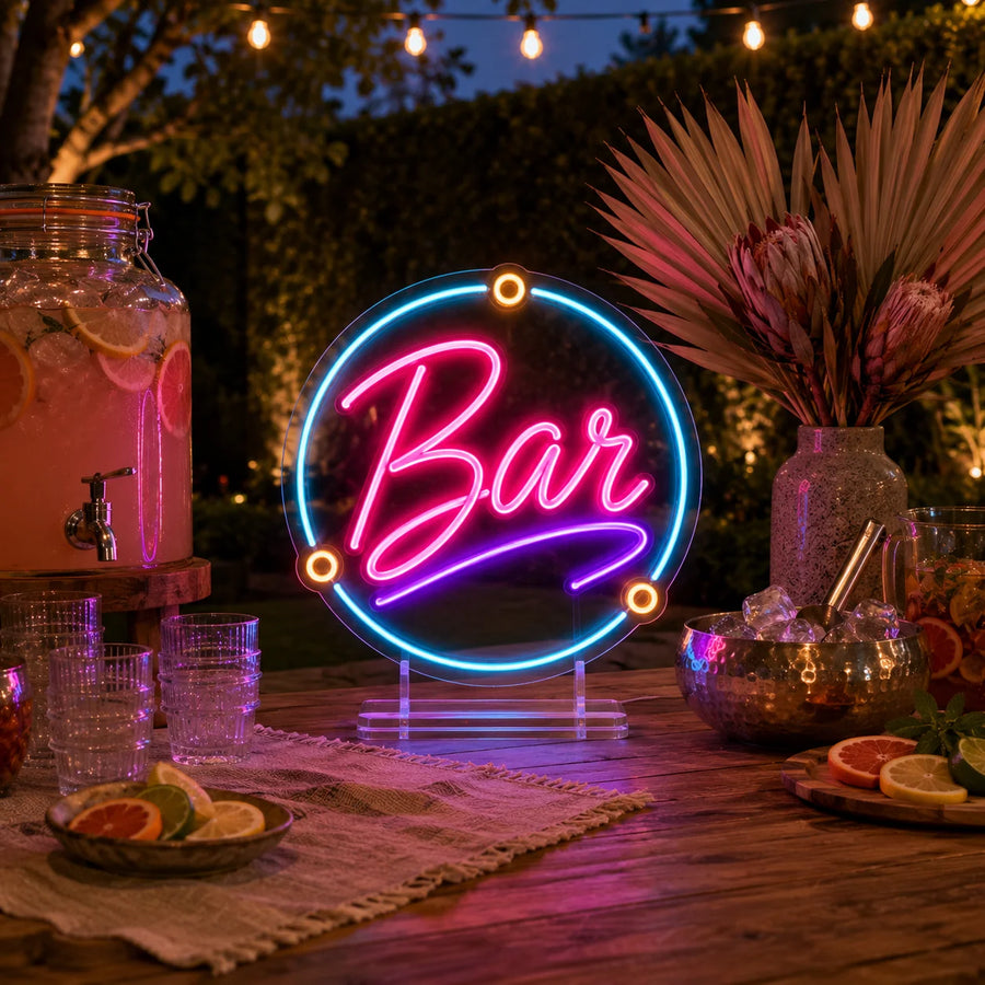 Round Bar tabletop neon sign on a wooden garden drinks table at dusk