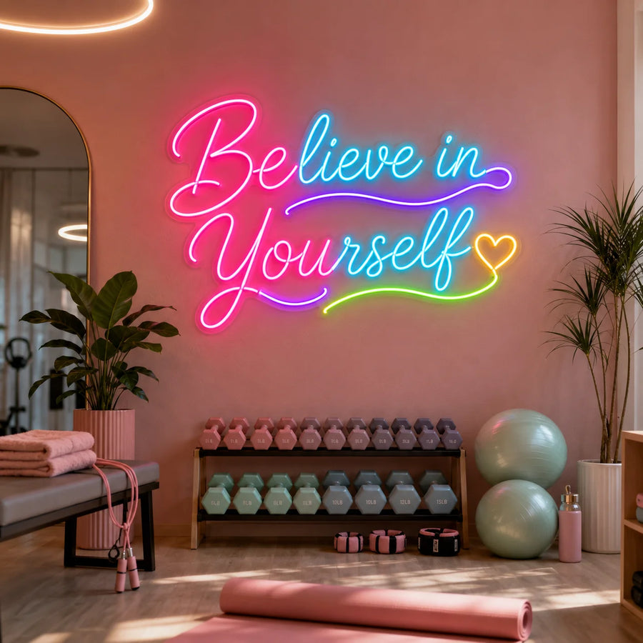 Believe In Yourself neon sign glowing on a pink home gym wall above a dumbbell rack