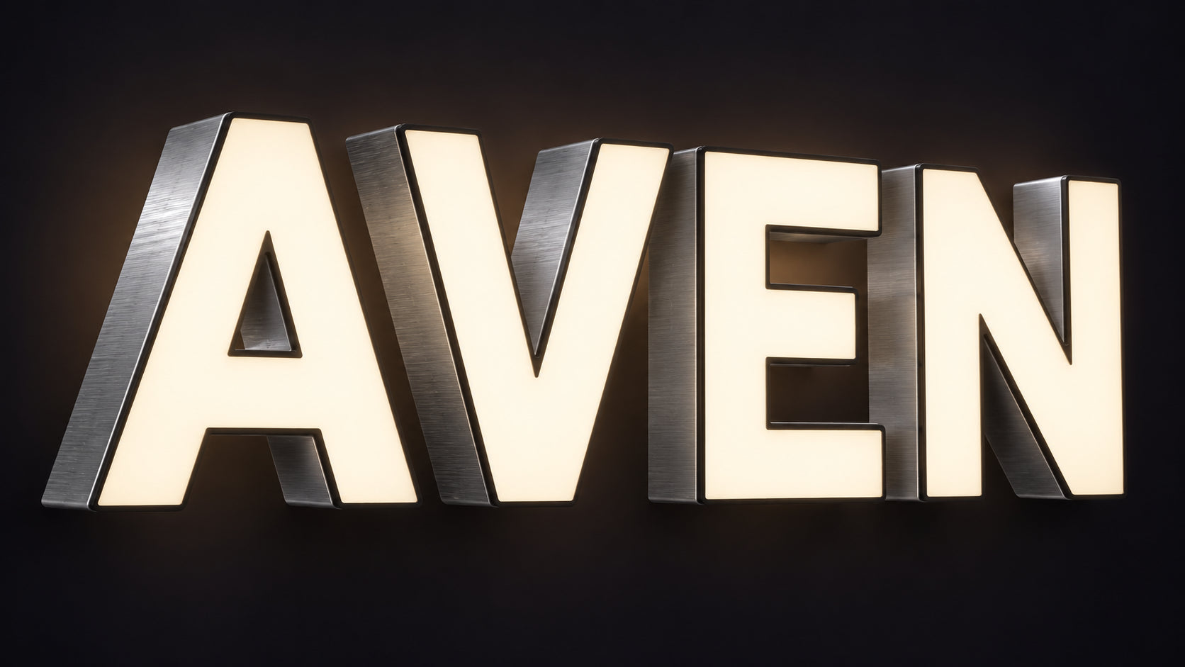 Front-lit LED channel letter sign spelling AVEN with glowing warm white acrylic faces and brushed aluminium returns