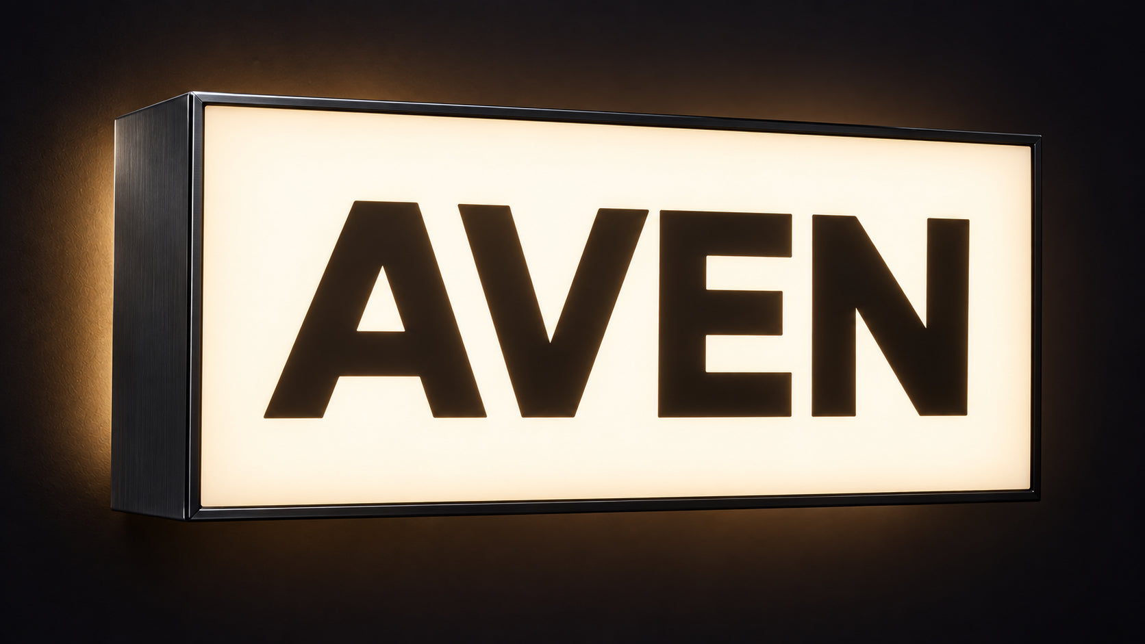 Illuminated lightbox cabinet sign with AVEN routed through a white acrylic face in a black aluminium frame