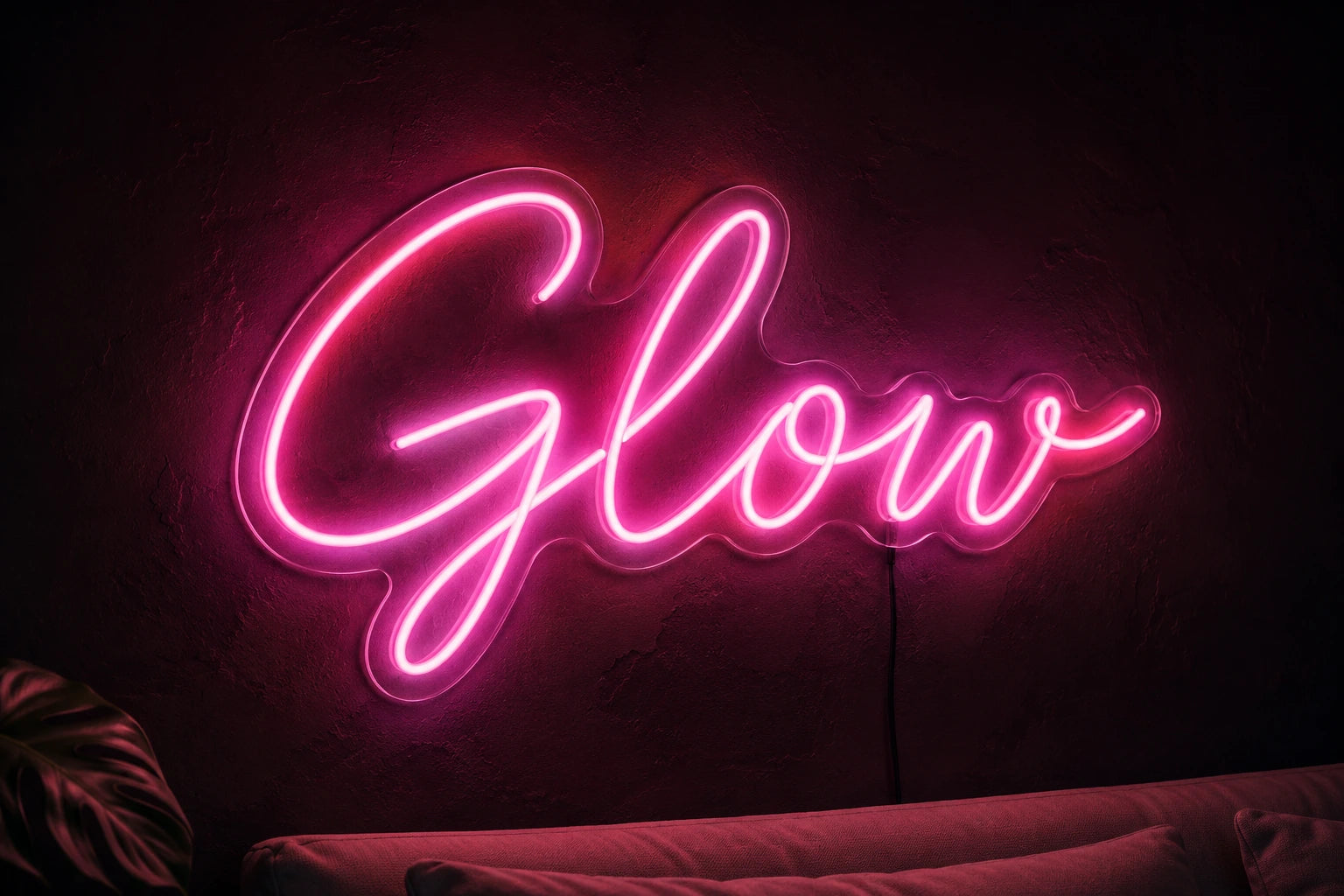 A pink LED neon flex sign reading Glow, mounted on an interior wall